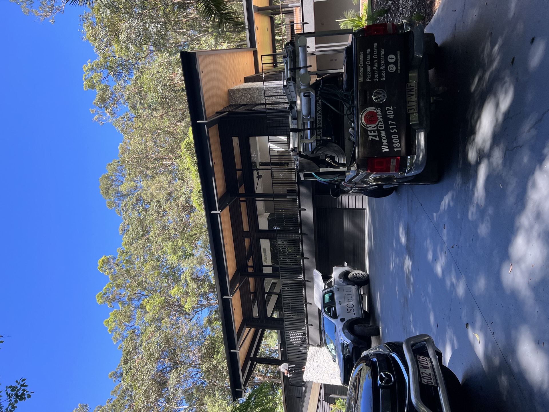 Zen Window Cleaning branded vehicle on-site at a Queenslander-style Gold Coast residence
