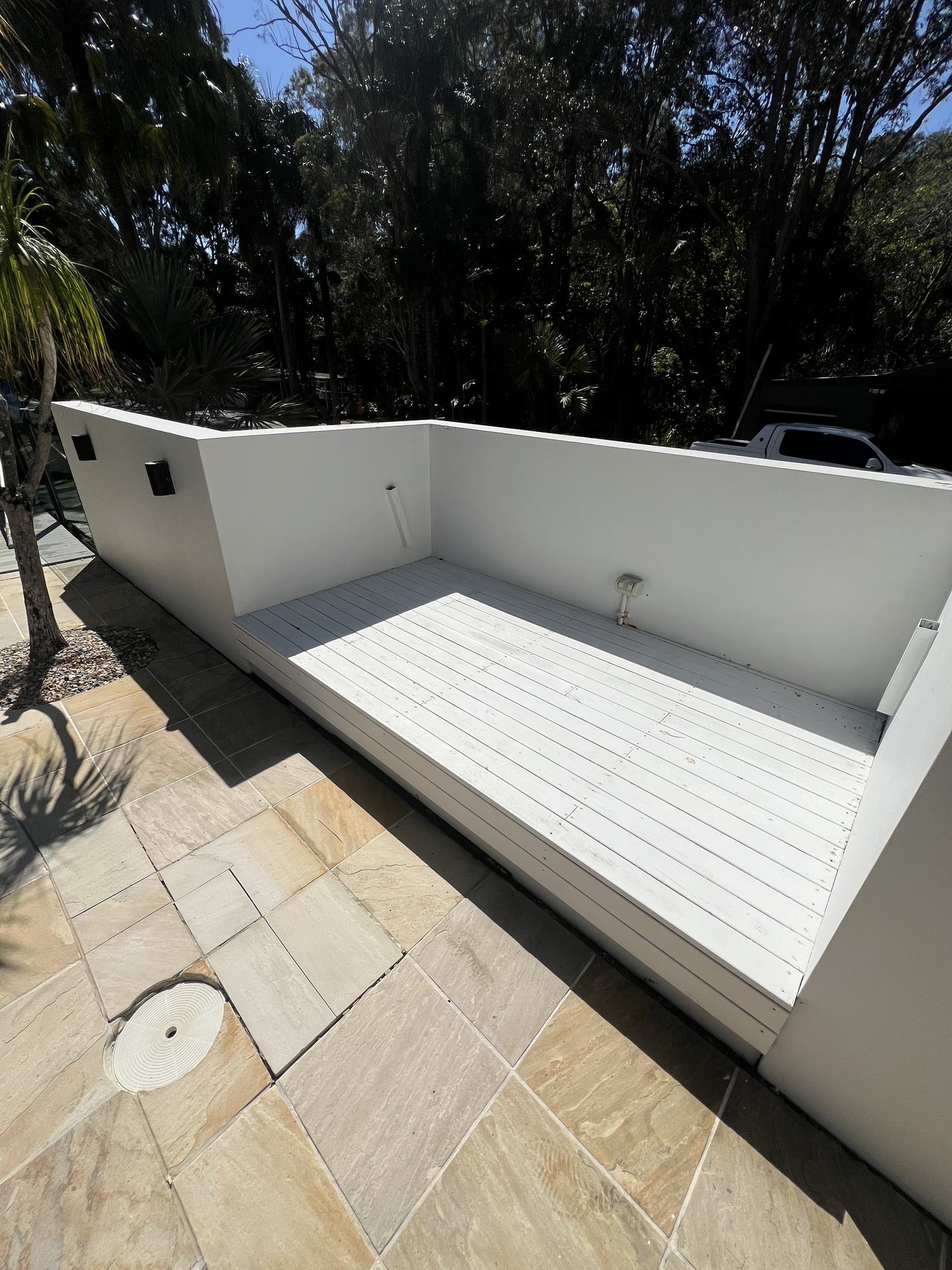 The same daybed deck after pressure cleaning, boards back to bright white