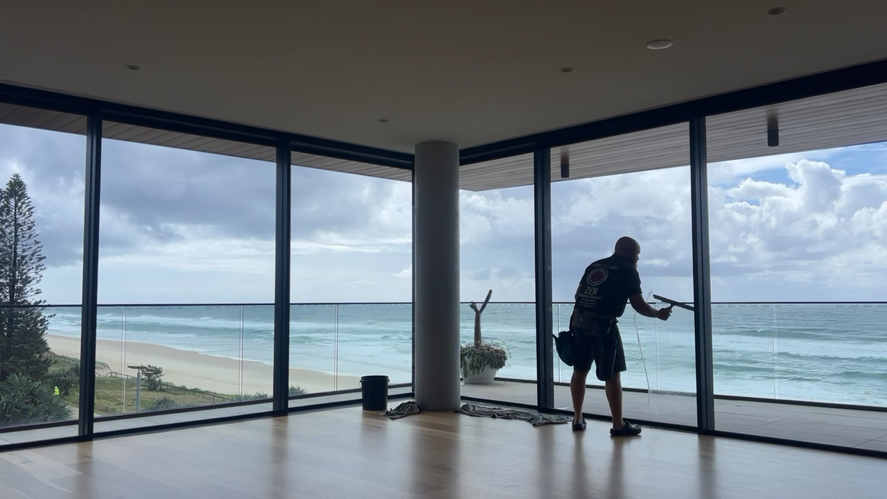 Rhys cleaning windows on a Gold Coast coastal residential property - Miami context
