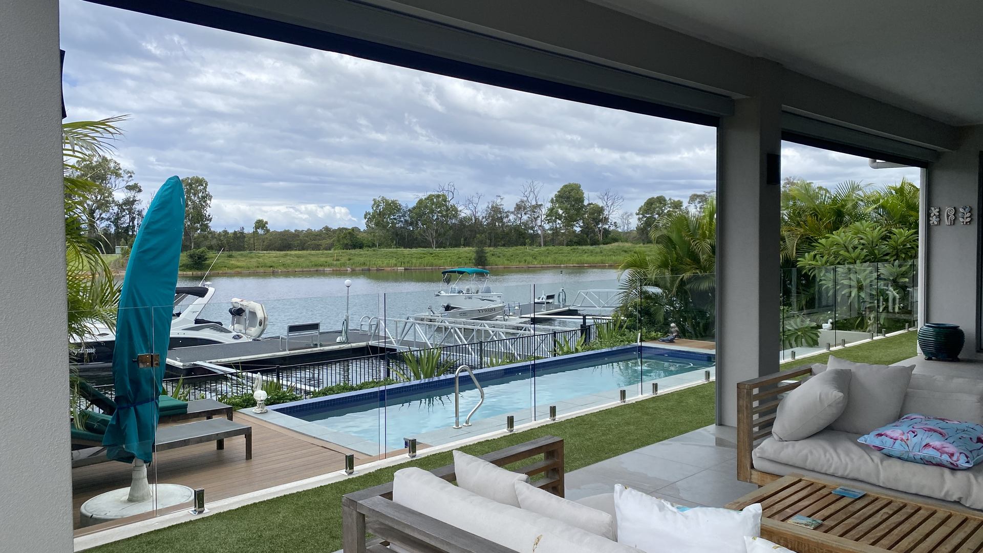 Freshly cleaned glass on a canal-front home in Helensvale, pool and pontoon beyond
