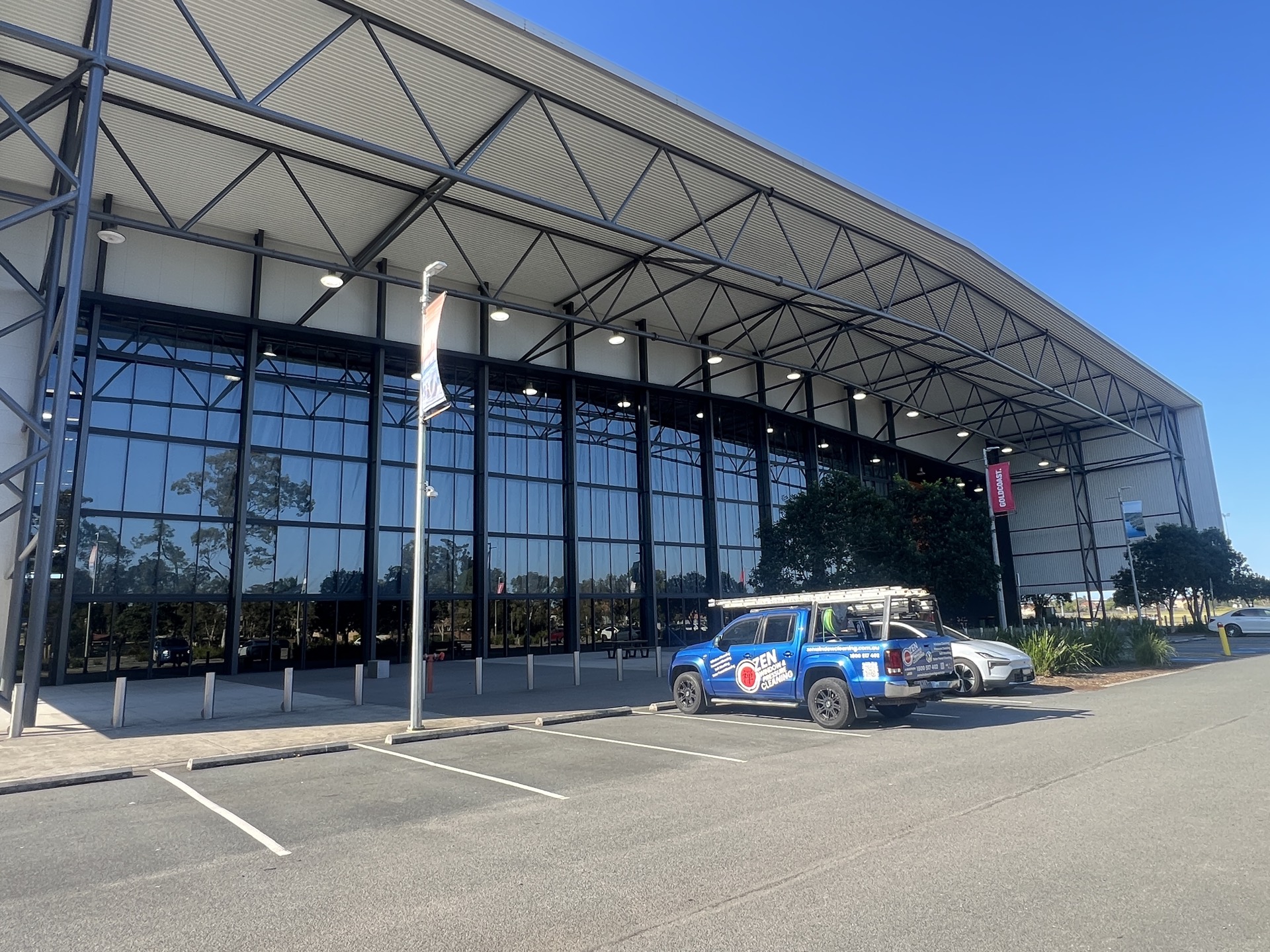 Zen Window Cleaning ute outside the glass front of the Coomera Indoor Sports Centre on Beattie Road