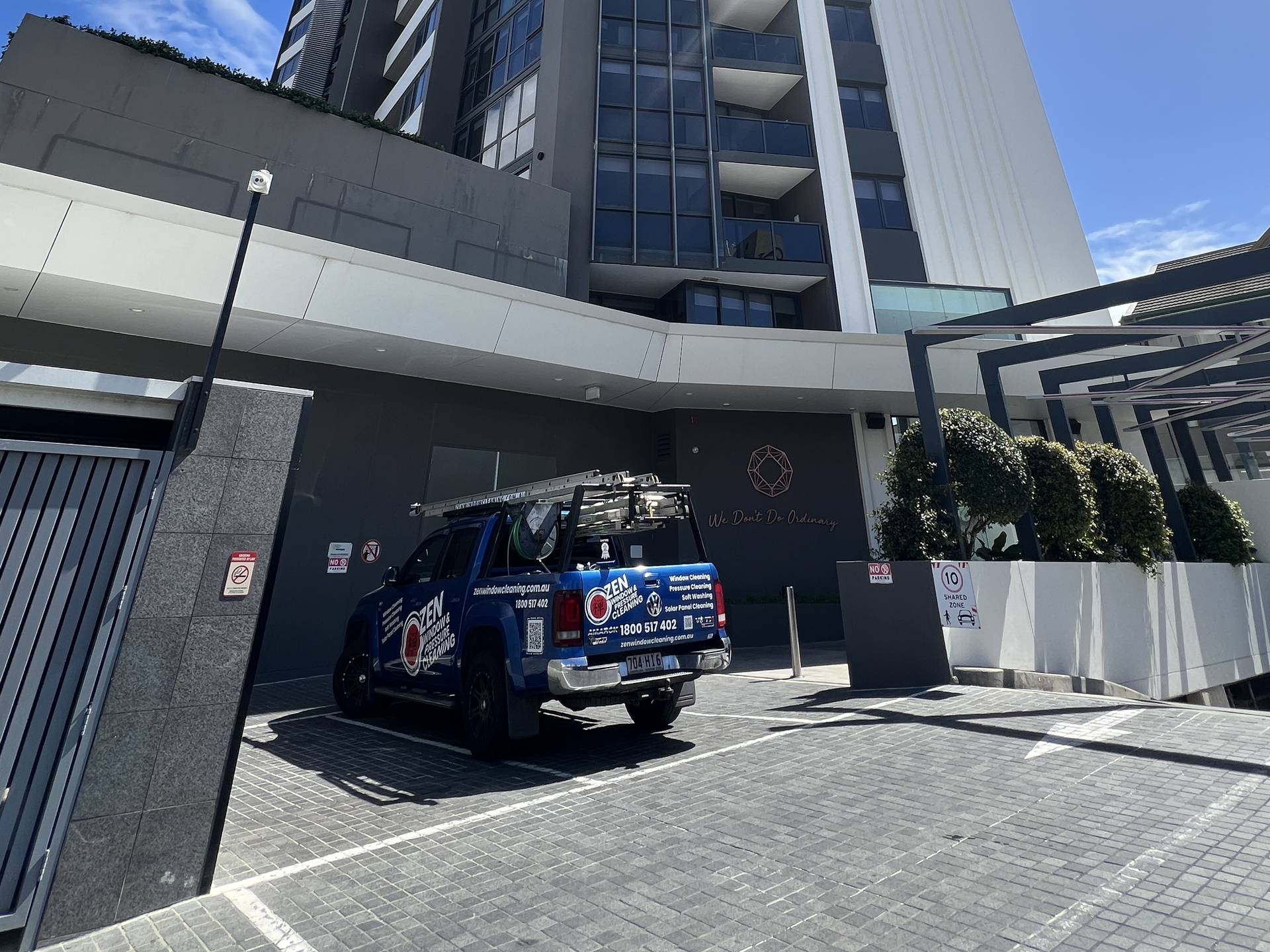 Zen Window Cleaning ute at the base of the Ruby apartment tower on Norfolk Avenue, Surfers Paradise