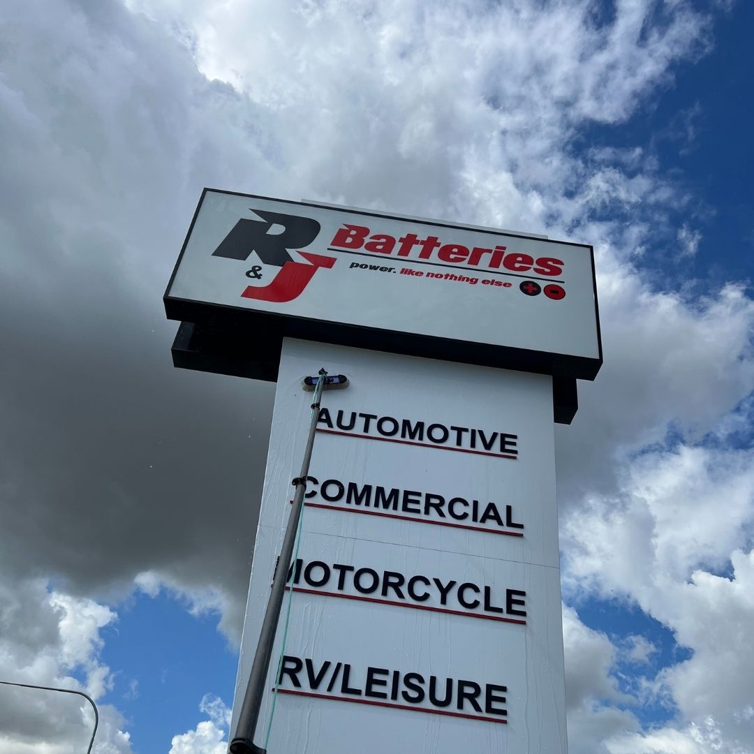 Signage cleaning on a Gold Coast commercial property - elevated signs reached with extended water-fed poles